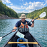 Paddler using an XR Gear leg-mounted map board on the water